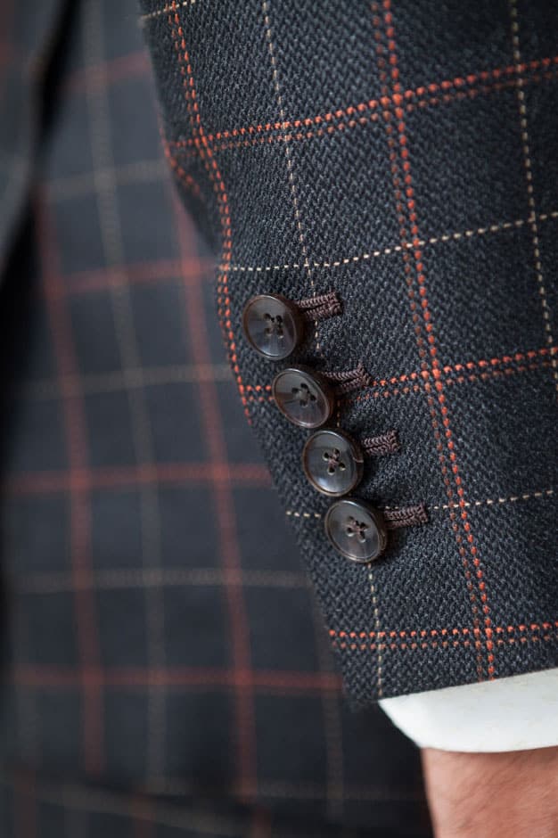 Horn buttons and handmade buttonholes of a silk suit