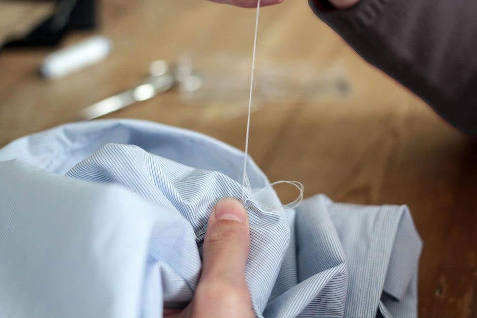 Sleeve of a bespoke dress shirt attached by hand